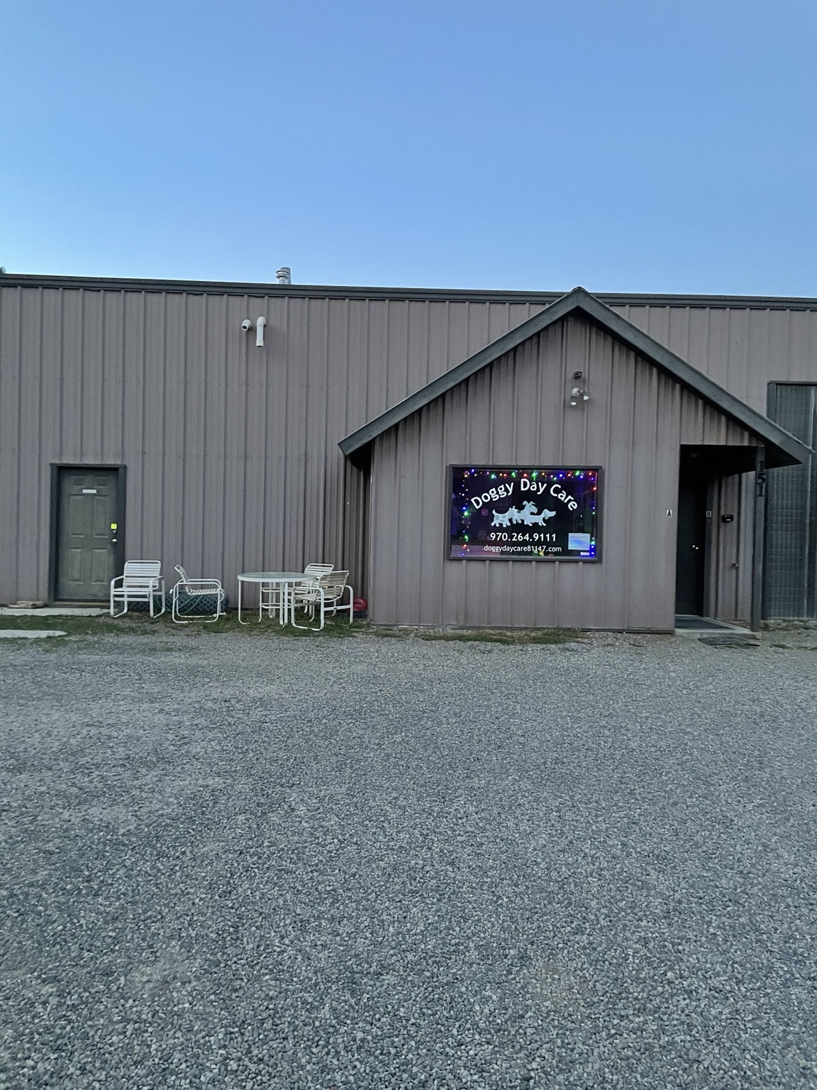 The front entrance and sign for Doggy Day Care 81147 in Pagosa Springs